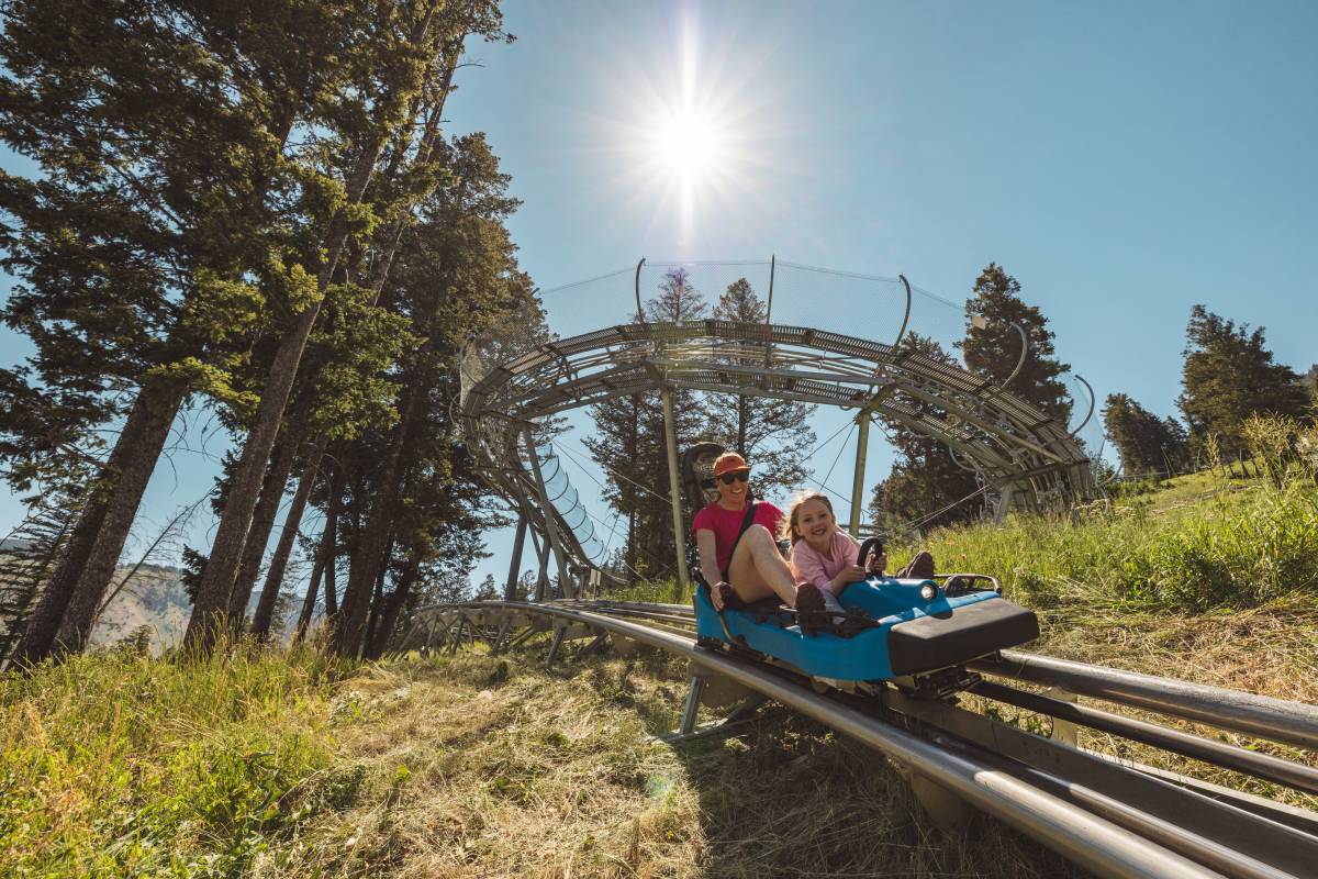 A mother and child ride the Cowboy Coaster at Snow King Mountain in Jackson Hole, WY.