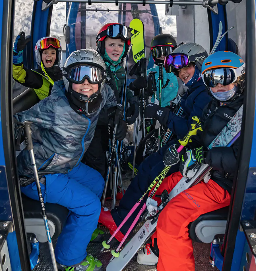 Kids with ski gear gather in the Gondola at Snow King Mountain in Jackson Hole, WY.