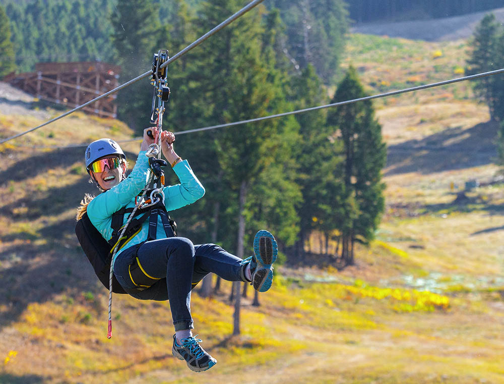 A person rides down the zip line at Snow King Mountain in Jackson Hole, WY.